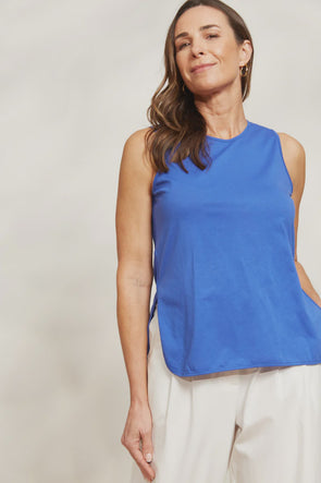 The Verano Tank is all about comfort and versatility, crafted with soft and stretchy cotton. Its sleeveless design and relaxed silhouette make it ideal for standalone wear or layering to elevate an outfit. With its adaptable style, the Verano Tank pairs effortlessly with jeans for a casual vibe or tucked into a maxi skirt or wide-leg trousers for a more polished look.