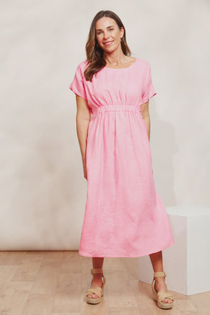 Picture yourself sipping cocktails by the pool or strolling through a charming villa courtyard—the Sojourn Dress is your go-to for those luxurious weekend getaways! This 100% linen midi dress features a round neck, an elastic waist detail and a flowing skirt to ensure you look and feel your best. Complete the look with a sunhat and sandals, and you're ready for your next summer adventure!