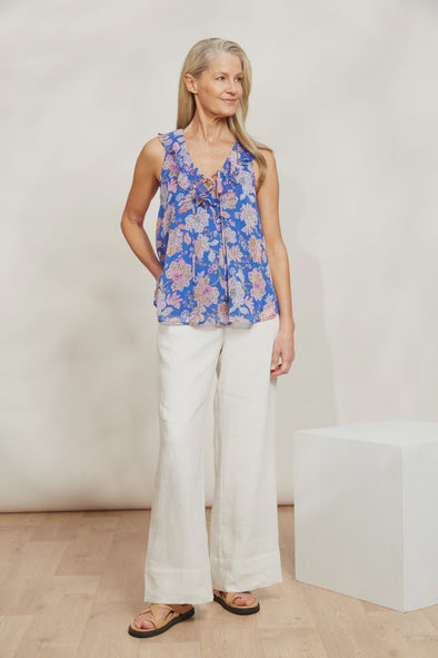 With a charming ruffle collar, V-neck, and playful drawstring, the Sereno Tank is perfect for any occasion. Shimmering lurex threading adds a lovely sparkle that will turn heads whether you're going out for dinner or hanging out with friends. Paired with linen pants or a breezy maxi skirt, don't forget to add some metallic accents for extra flair!