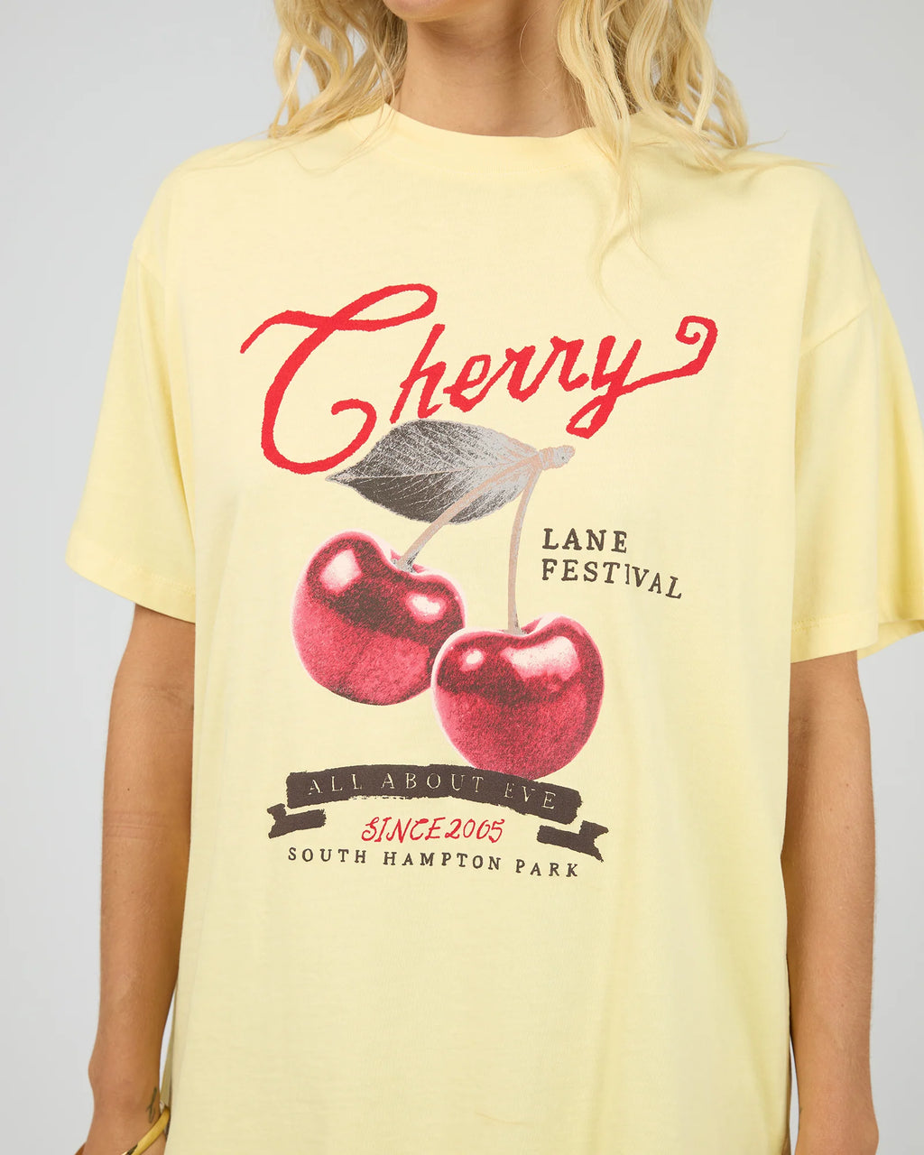 Introducing the Pippa Relaxed Tee in Yellow, designed to add a subtle pop of yellow to your wardrobe. Crafted from cotton, it features a relaxed fit silhouette with an All About Eve exclusive cherry graphic, delivering comfort and effortless wear. Style it casually for brunch with the girls, or pair it back with your favourite denim jeans for relaxed family gatherings.v