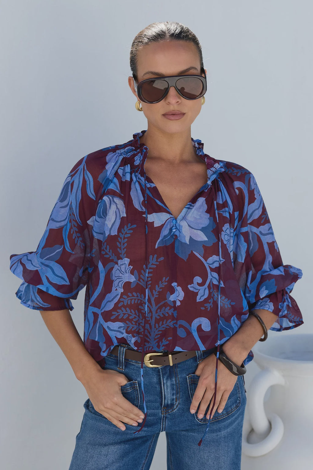 - V-neckline
- Shirred neckline
- Short puff sleeves
- Shirred cuffs with frill detailing
- Delicate front button detail
- Adjustable neckline ties
- Relaxed oversized fit
- Delicate garment care
- Fabric Composition - 80% Viscose 20% Nylon