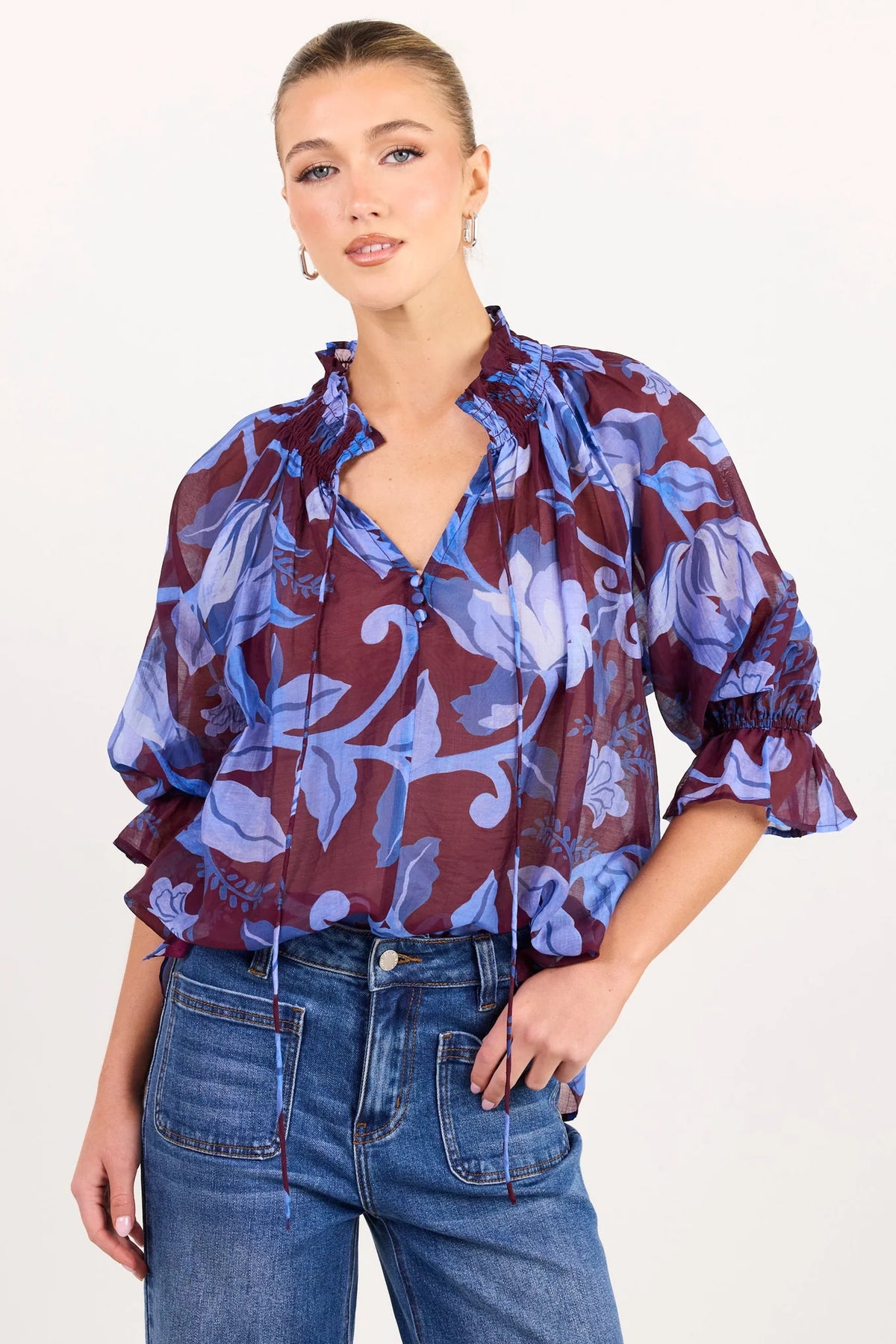 - V-neckline
- Shirred neckline
- Short puff sleeves
- Shirred cuffs with frill detailing
- Delicate front button detail
- Adjustable neckline ties
- Relaxed oversized fit
- Delicate garment care
- Fabric Composition - 80% Viscose 20% Nylon