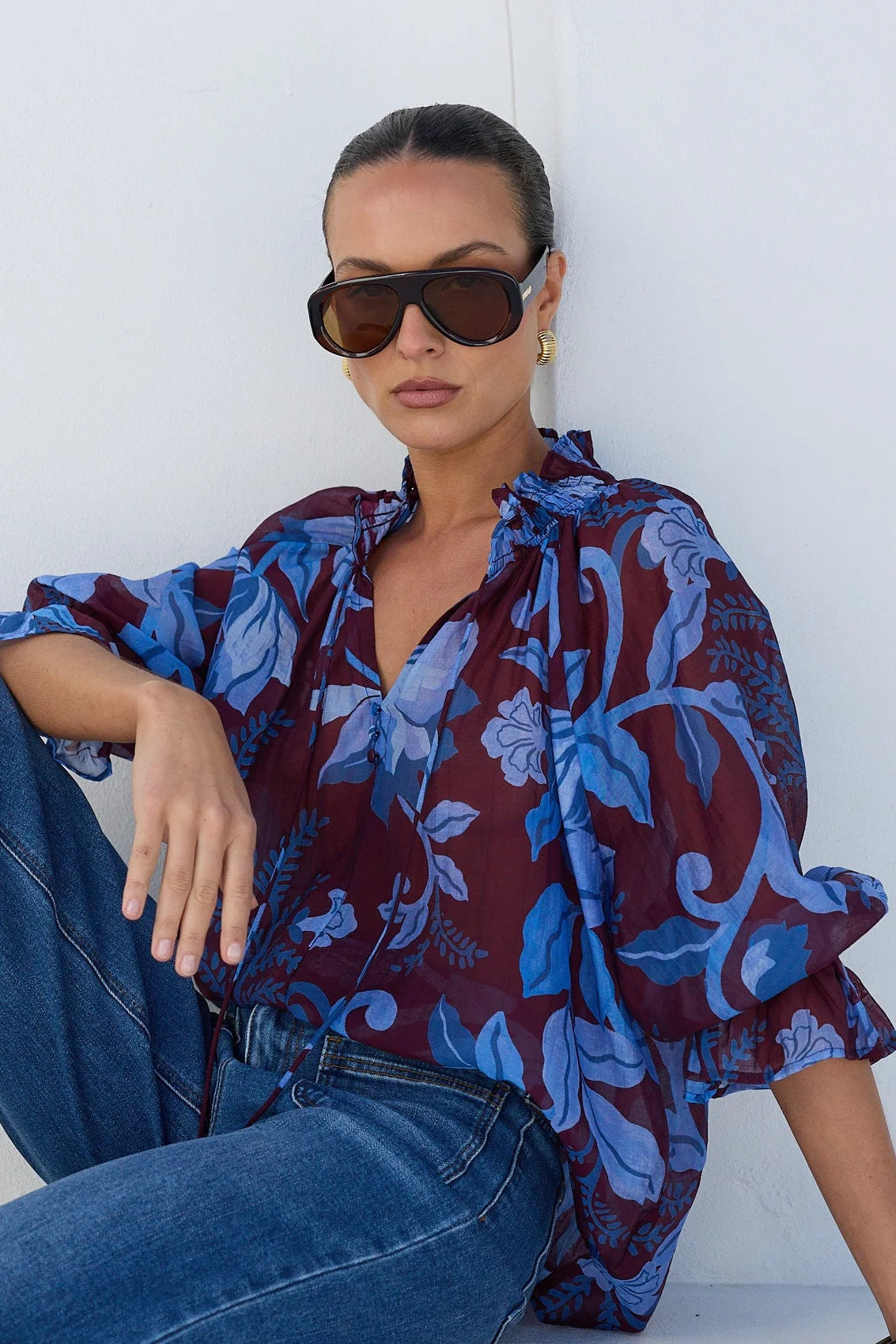 - V-neckline
- Shirred neckline
- Short puff sleeves
- Shirred cuffs with frill detailing
- Delicate front button detail
- Adjustable neckline ties
- Relaxed oversized fit
- Delicate garment care
- Fabric Composition - 80% Viscose 20% Nylon