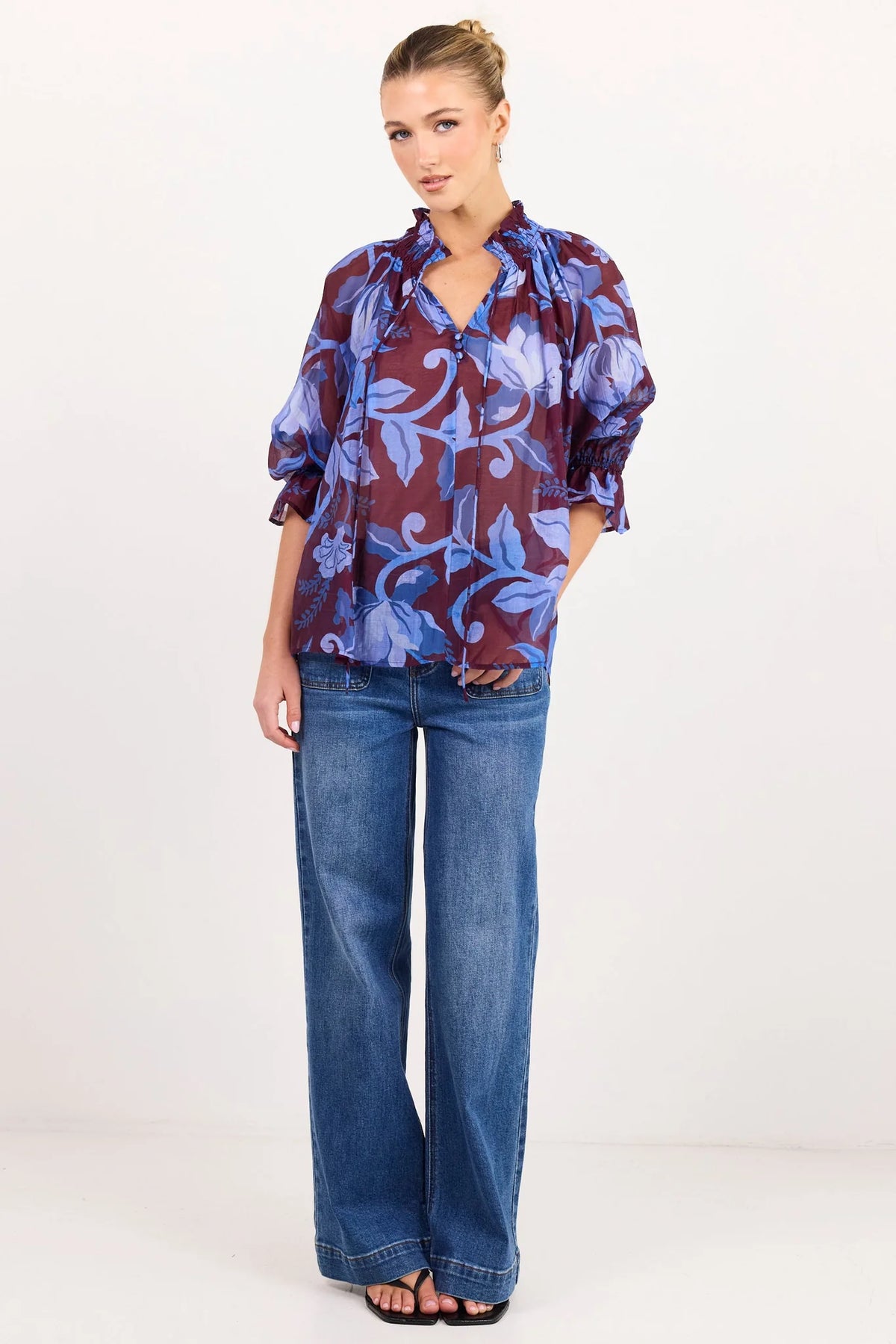 - V-neckline
- Shirred neckline
- Short puff sleeves
- Shirred cuffs with frill detailing
- Delicate front button detail
- Adjustable neckline ties
- Relaxed oversized fit
- Delicate garment care
- Fabric Composition - 80% Viscose 20% Nylon