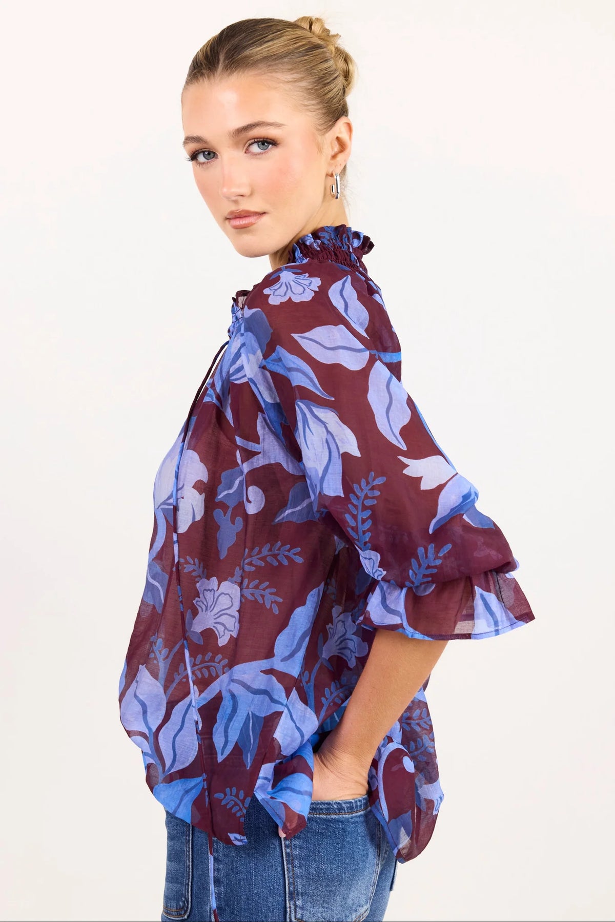 - V-neckline
- Shirred neckline
- Short puff sleeves
- Shirred cuffs with frill detailing
- Delicate front button detail
- Adjustable neckline ties
- Relaxed oversized fit
- Delicate garment care
- Fabric Composition - 80% Viscose 20% Nylon