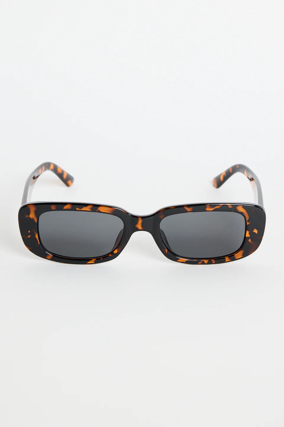 The Malibu Brown Tort Sunglasses bring bold, retro-cool energy to your everyday looks. Featuring a striking tortoiseshell frame and a sleek rectangular silhouette, they balance fashion-forward attitude with easy wearability. The dark tinted lenses keep the finish sharp and versatile, making this pair a go-to for sunny days, weekend plans, and everything in between.

A standout accessory that adds instant style.