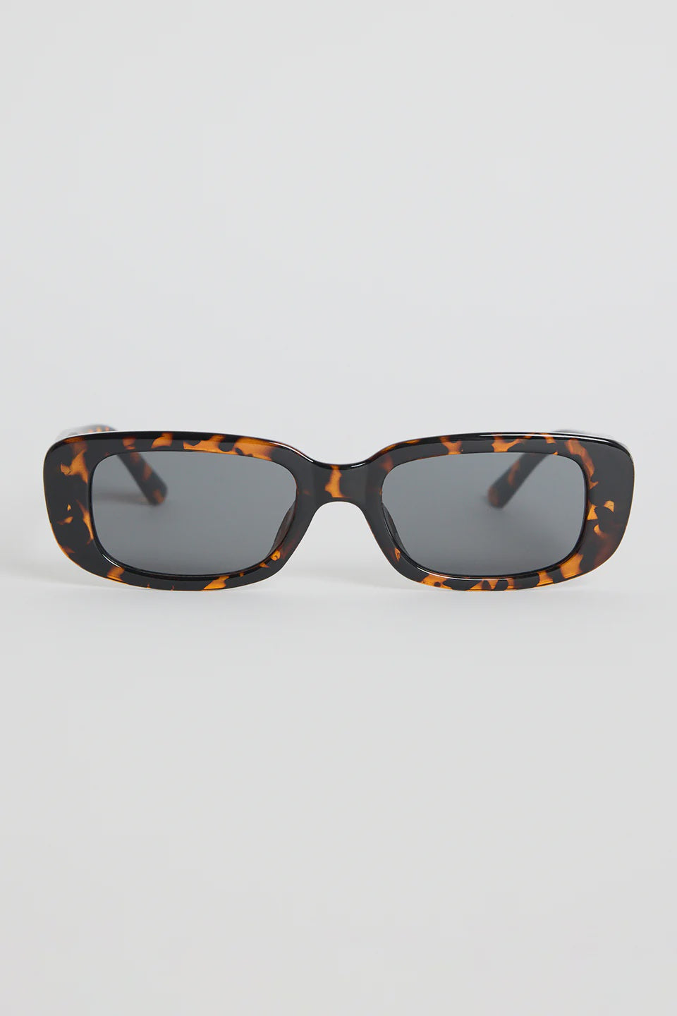 The Malibu Brown Tort Sunglasses bring bold, retro-cool energy to your everyday looks. Featuring a striking tortoiseshell frame and a sleek rectangular silhouette, they balance fashion-forward attitude with easy wearability. The dark tinted lenses keep the finish sharp and versatile, making this pair a go-to for sunny days, weekend plans, and everything in between.

A standout accessory that adds instant style.