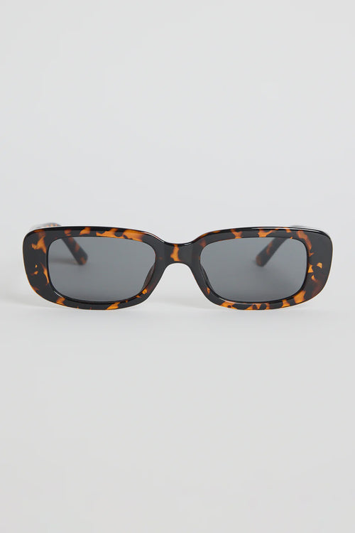 The Malibu Brown Tort Sunglasses bring bold, retro-cool energy to your everyday looks. Featuring a striking tortoiseshell frame and a sleek rectangular silhouette, they balance fashion-forward attitude with easy wearability. The dark tinted lenses keep the finish sharp and versatile, making this pair a go-to for sunny days, weekend plans, and everything in between.

A standout accessory that adds instant style.