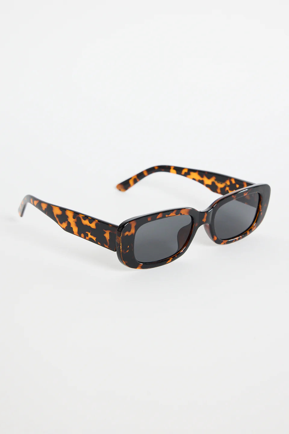 The Malibu Brown Tort Sunglasses bring bold, retro-cool energy to your everyday looks. Featuring a striking tortoiseshell frame and a sleek rectangular silhouette, they balance fashion-forward attitude with easy wearability. The dark tinted lenses keep the finish sharp and versatile, making this pair a go-to for sunny days, weekend plans, and everything in between.

A standout accessory that adds instant style.