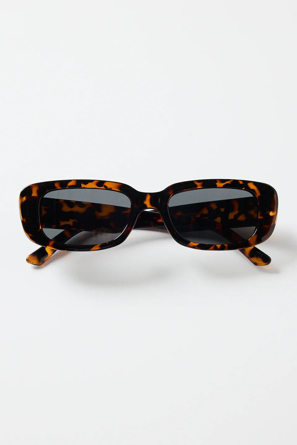The Malibu Brown Tort Sunglasses bring bold, retro-cool energy to your everyday looks. Featuring a striking tortoiseshell frame and a sleek rectangular silhouette, they balance fashion-forward attitude with easy wearability. The dark tinted lenses keep the finish sharp and versatile, making this pair a go-to for sunny days, weekend plans, and everything in between.

A standout accessory that adds instant style.