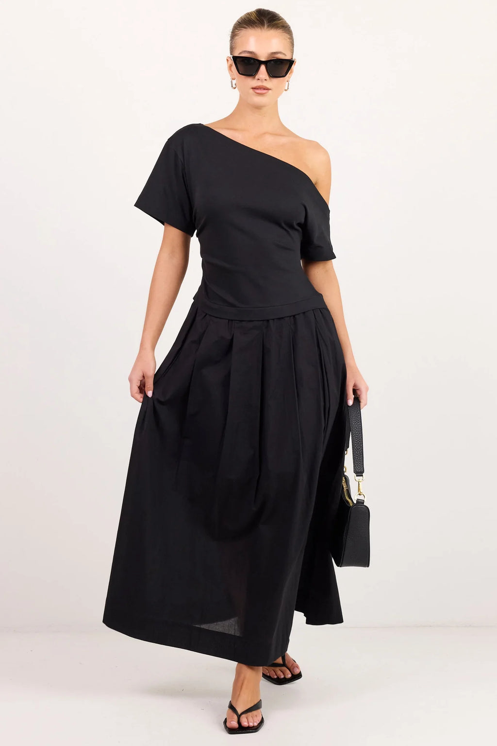 - Asymmetric off-shoulder neckline
- Short sleeves
- Fitted through the waist
- Softly gathered maxi skirt
- Pull-on design
- Natural fibre
- Fabric Composition - 100% Cotton