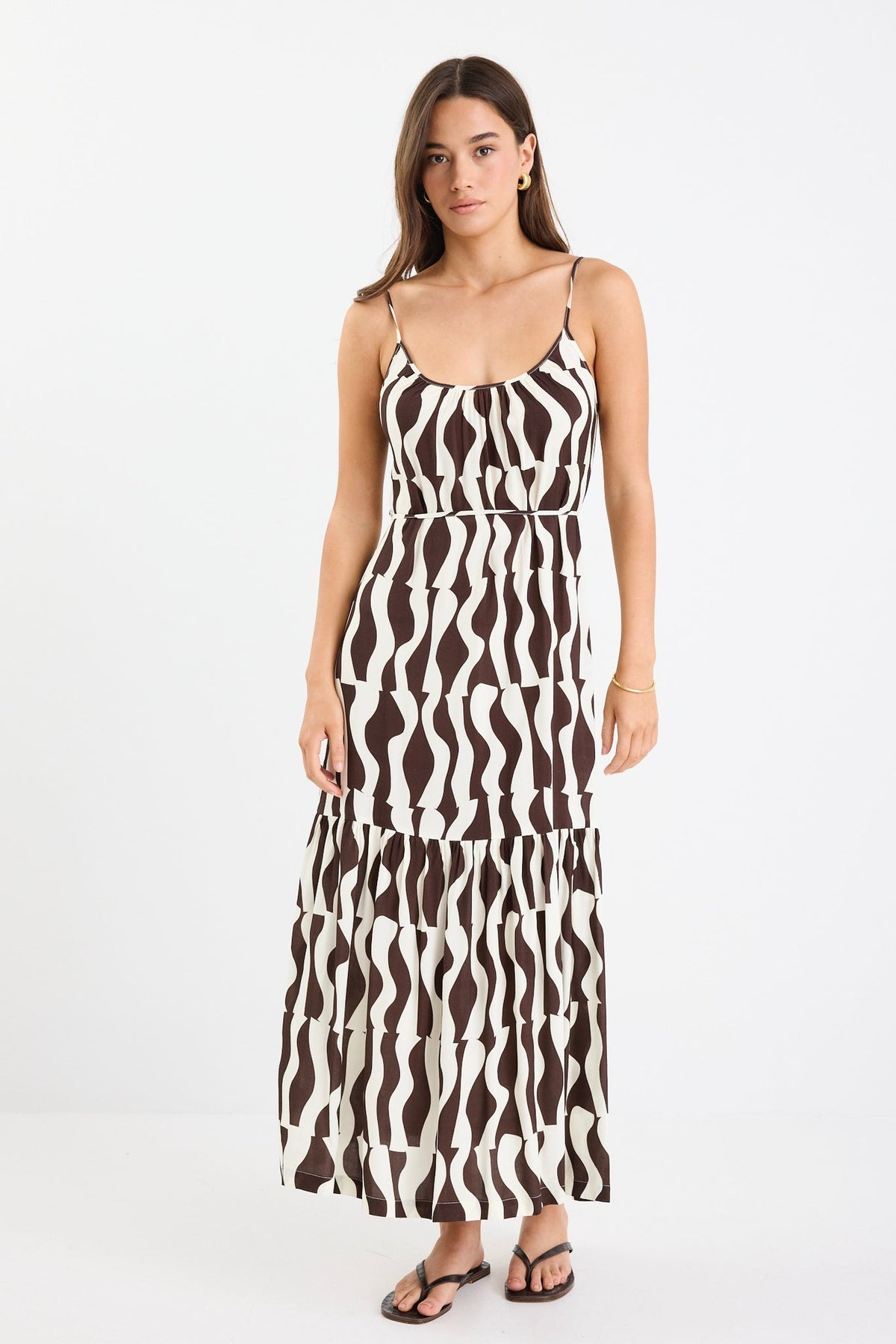 Bold chocolate and cream geometric print

Strappy sleeves for a relaxed summer feel

Tiered design for movement and flow

Lightweight, breathable fabrication

Easy, throw-on silhouette for everyday wear

Fabric Composition
100% Viscose