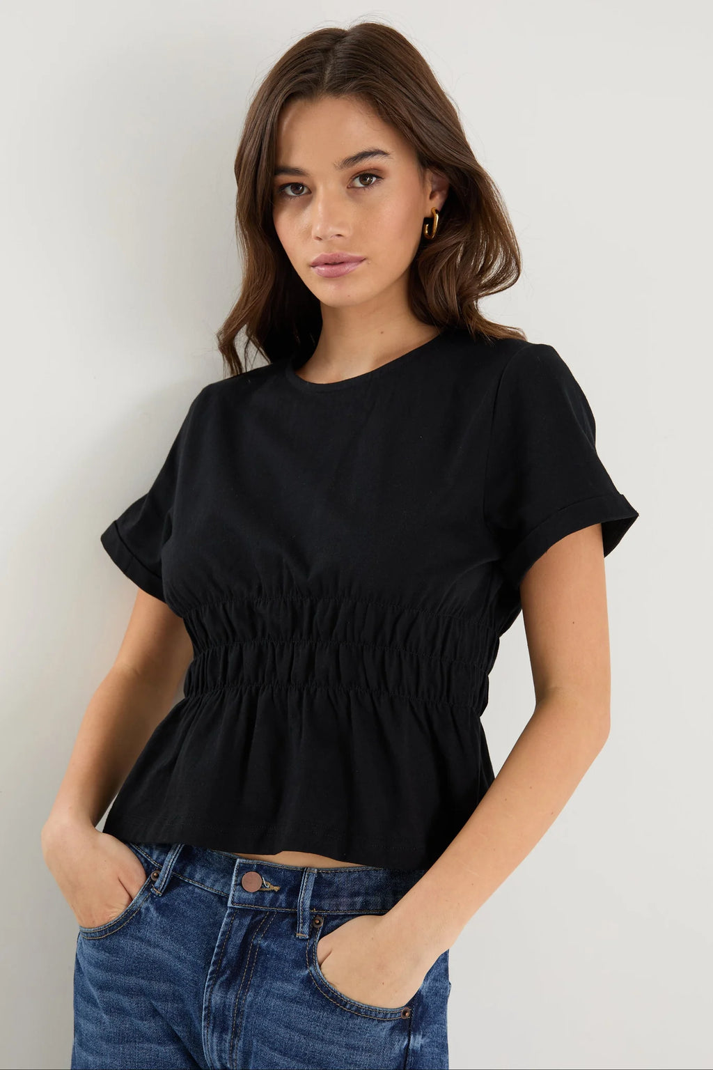 Classic crew neckline for timeless style

Short sleeves with rolled cuffs

Shirred waist detail for a flattering, tailored fit

Flared peplum-style hem for feminine movement

Made from soft, breathable 100% cotton