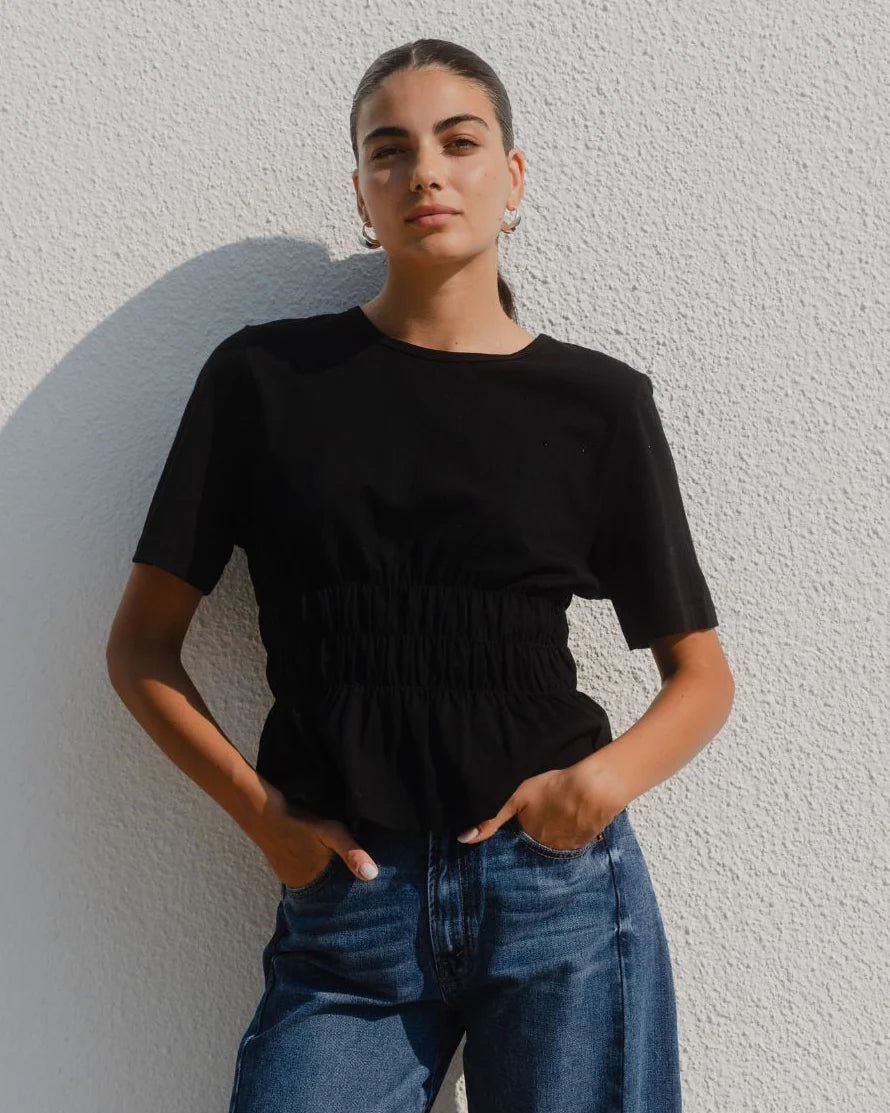 Classic crew neckline for timeless style

Short sleeves with rolled cuffs

Shirred waist detail for a flattering, tailored fit

Flared peplum-style hem for feminine movement

Made from soft, breathable 100% cotton