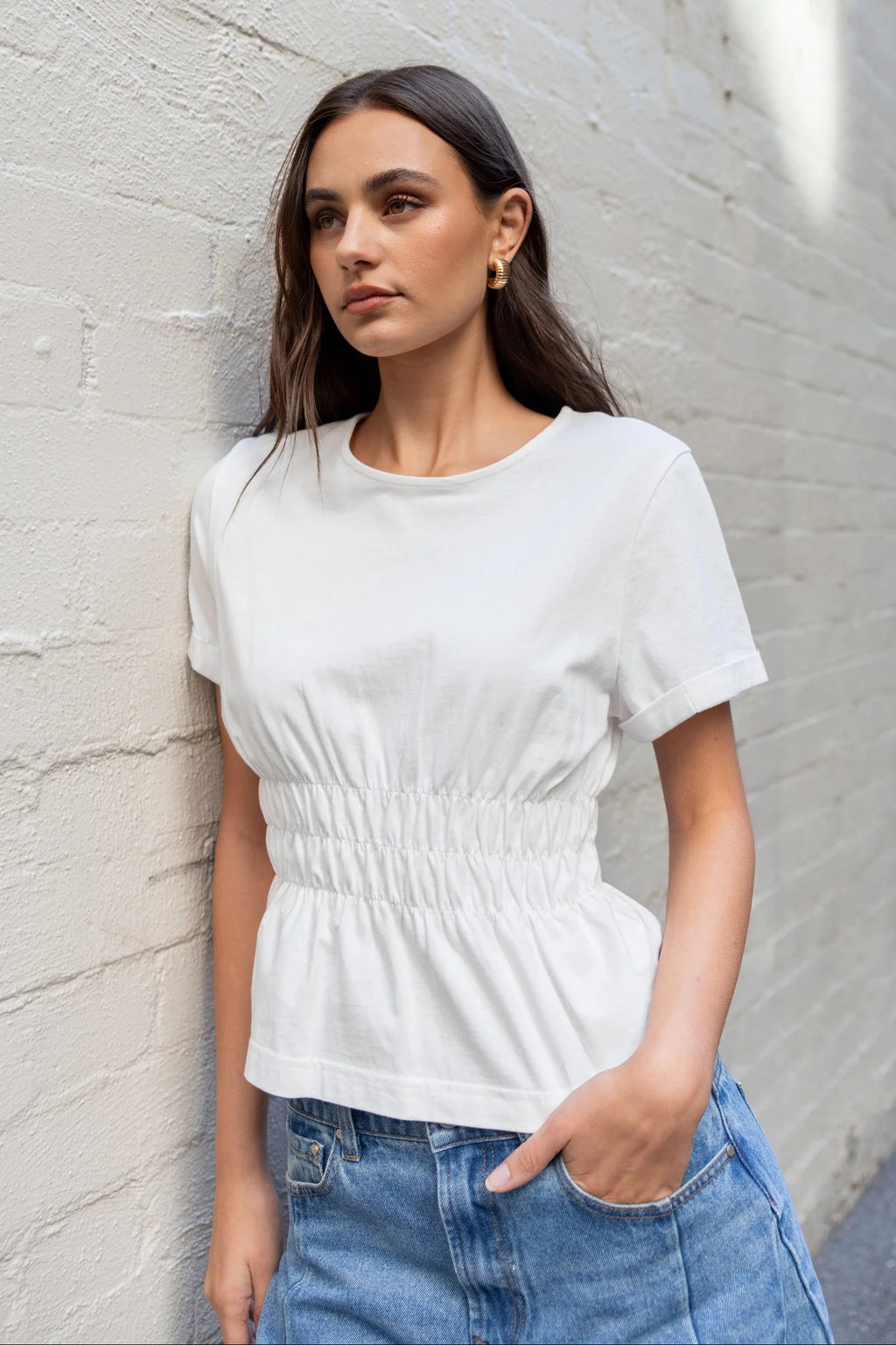 Classic crew neckline for timeless style

Short sleeves with rolled cuffs

Shirred waist detail for a flattering, tailored fit

Flared peplum-style hem for feminine movement

Made from soft, breathable 100% cotton