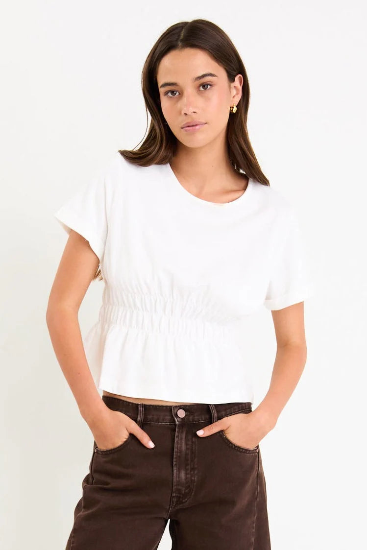 Classic crew neckline for timeless style

Short sleeves with rolled cuffs

Shirred waist detail for a flattering, tailored fit

Flared peplum-style hem for feminine movement

Made from soft, breathable 100% cotton