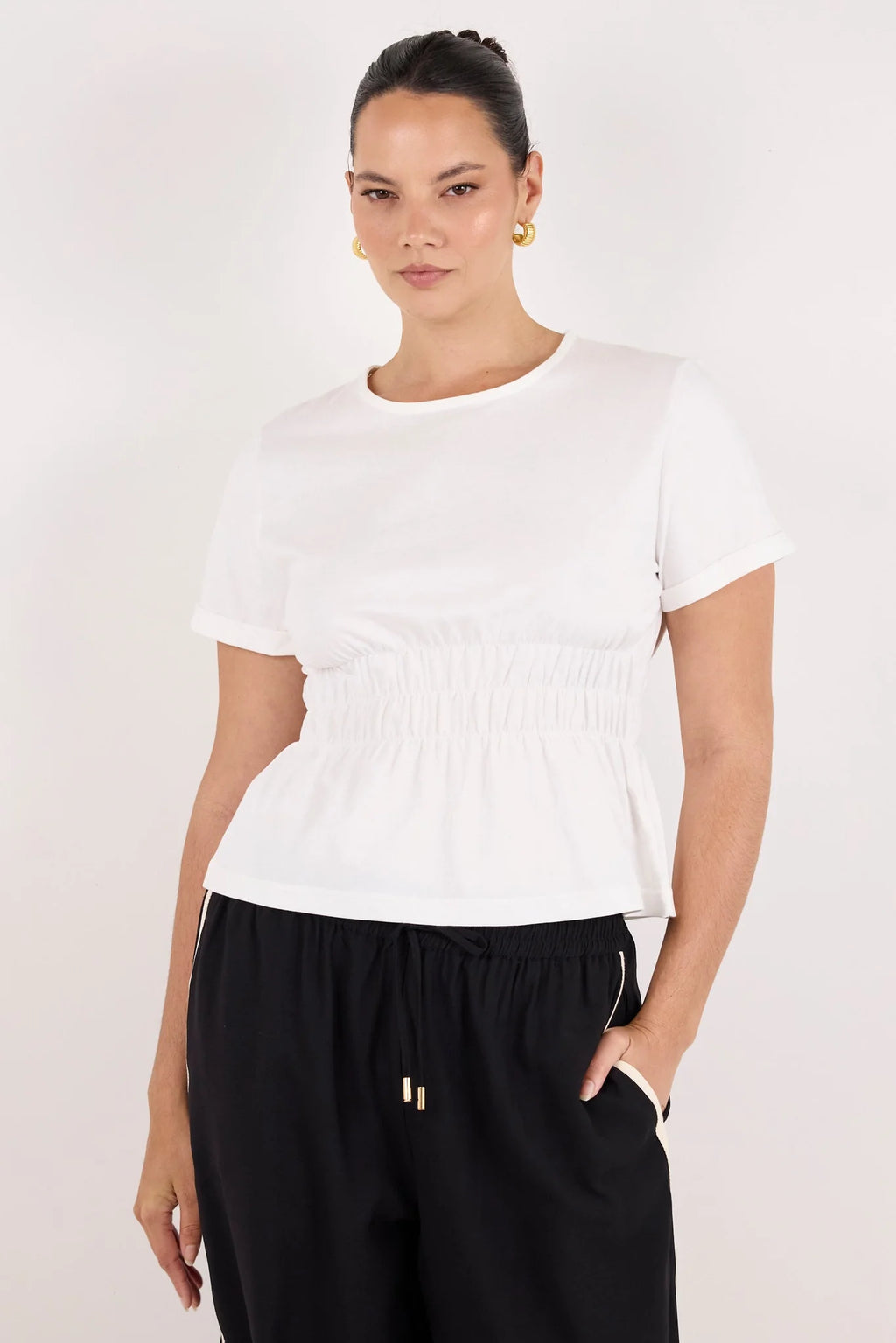 Classic crew neckline for timeless style

Short sleeves with rolled cuffs

Shirred waist detail for a flattering, tailored fit

Flared peplum-style hem for feminine movement

Made from soft, breathable 100% cotton