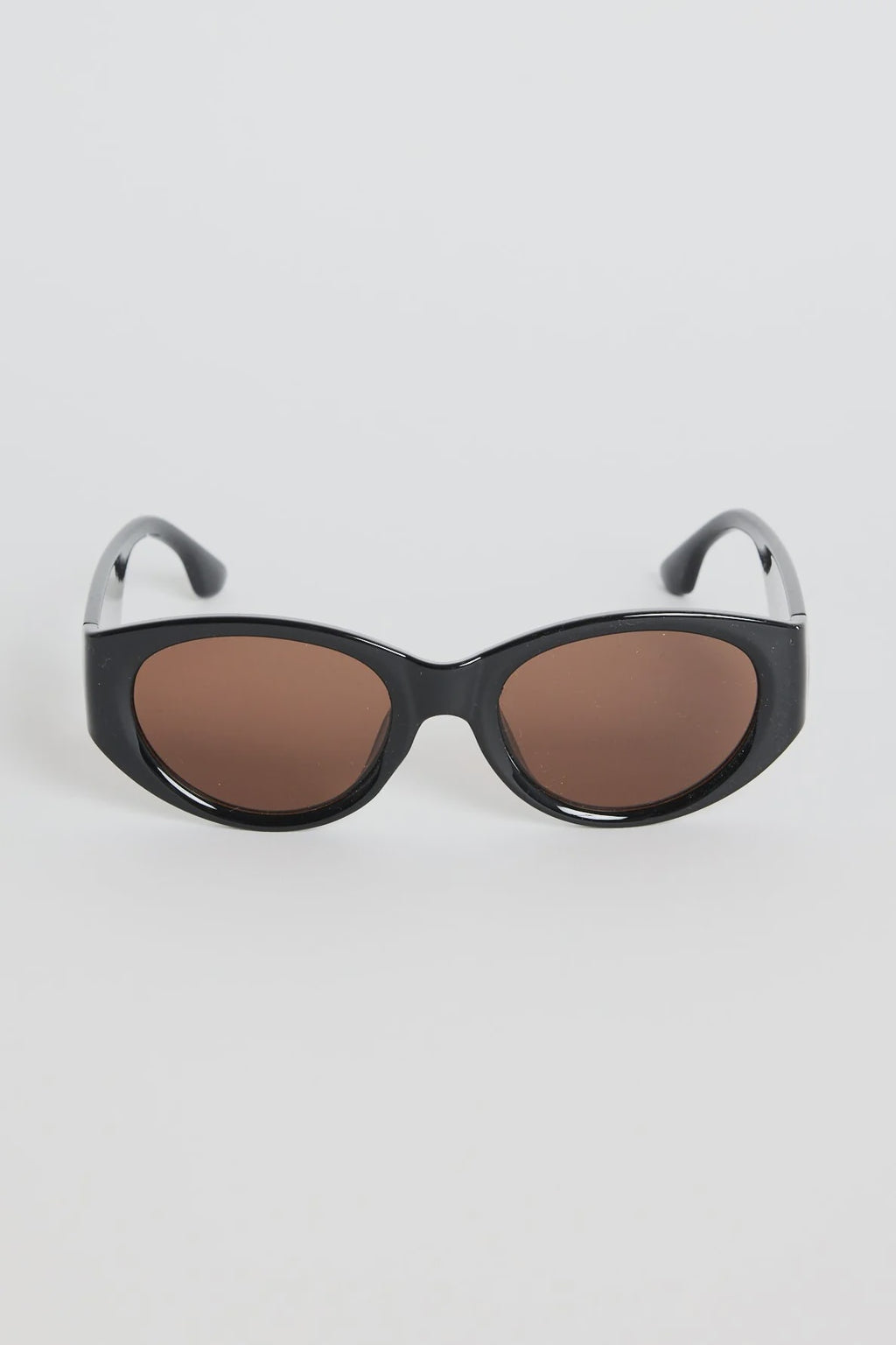 Bold, modern, and effortlessly cool, the Tokyo Black Sunglasses are made to elevate your everyday look. The glossy black frame brings a sleek, sculpted feel, while the rounded cat-eye silhouette adds just the right amount of attitude. Finished with warm brown lenses for a softened contrast, this pair works with everything from laid-back tees to your favourite linen sets.

A statement staple that always looks polished.
