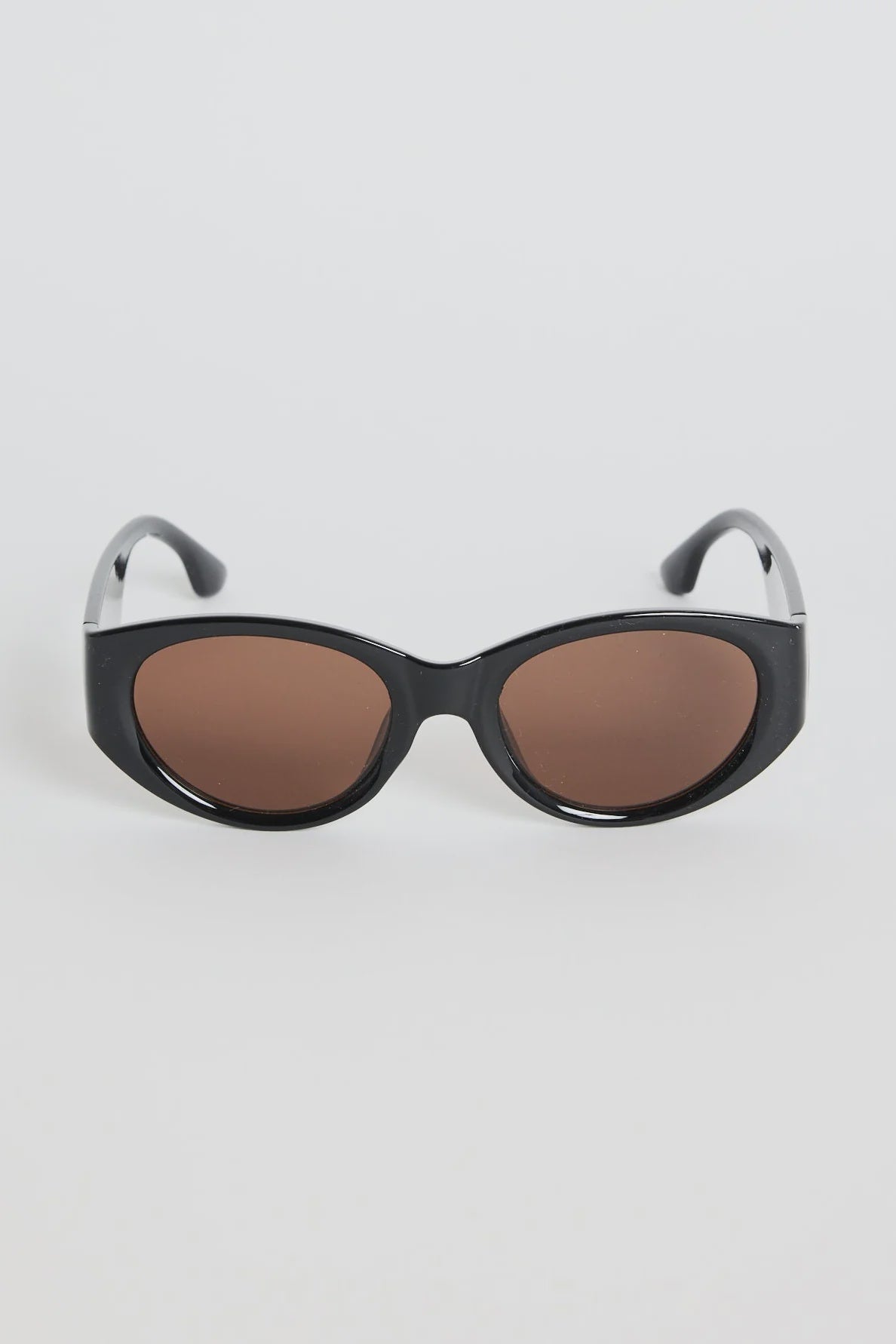 Bold, modern, and effortlessly cool, the Tokyo Black Sunglasses are made to elevate your everyday look. The glossy black frame brings a sleek, sculpted feel, while the rounded cat-eye silhouette adds just the right amount of attitude. Finished with warm brown lenses for a softened contrast, this pair works with everything from laid-back tees to your favourite linen sets.

A statement staple that always looks polished.