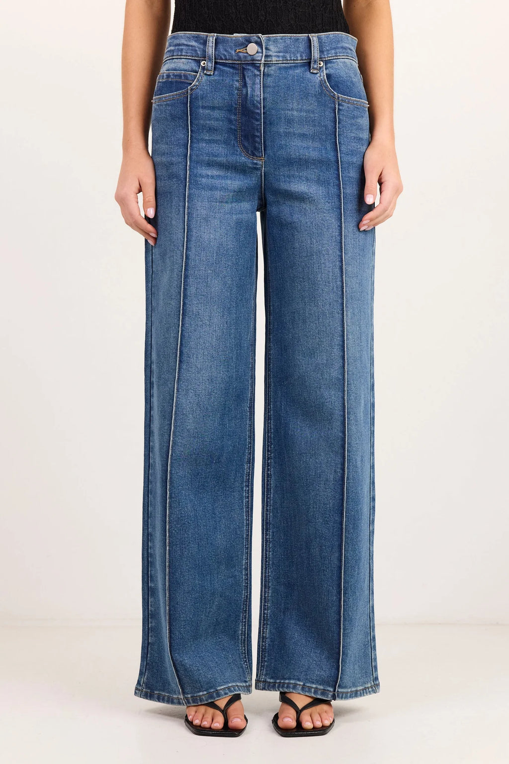 - High-rise fit
- Full-length flared leg
- Front pintuck detailing
- Zip fly with button closure
- Comfort-stretch denim
- Vintage blue wash
- Fabric Composition: 72% Cotton, 27% Polyester, 1% Elastane