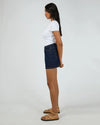 Mid-rise waist for a flattering everyday fit

Crafted from rigid 100% cotton denim

Mini length with hidden skort detail for added coverage

Functional front and back pockets

Stitched hem for a clean, structured finish

Shank button closure for a classic denim look

Vintage wash for an effortlessly cool feel