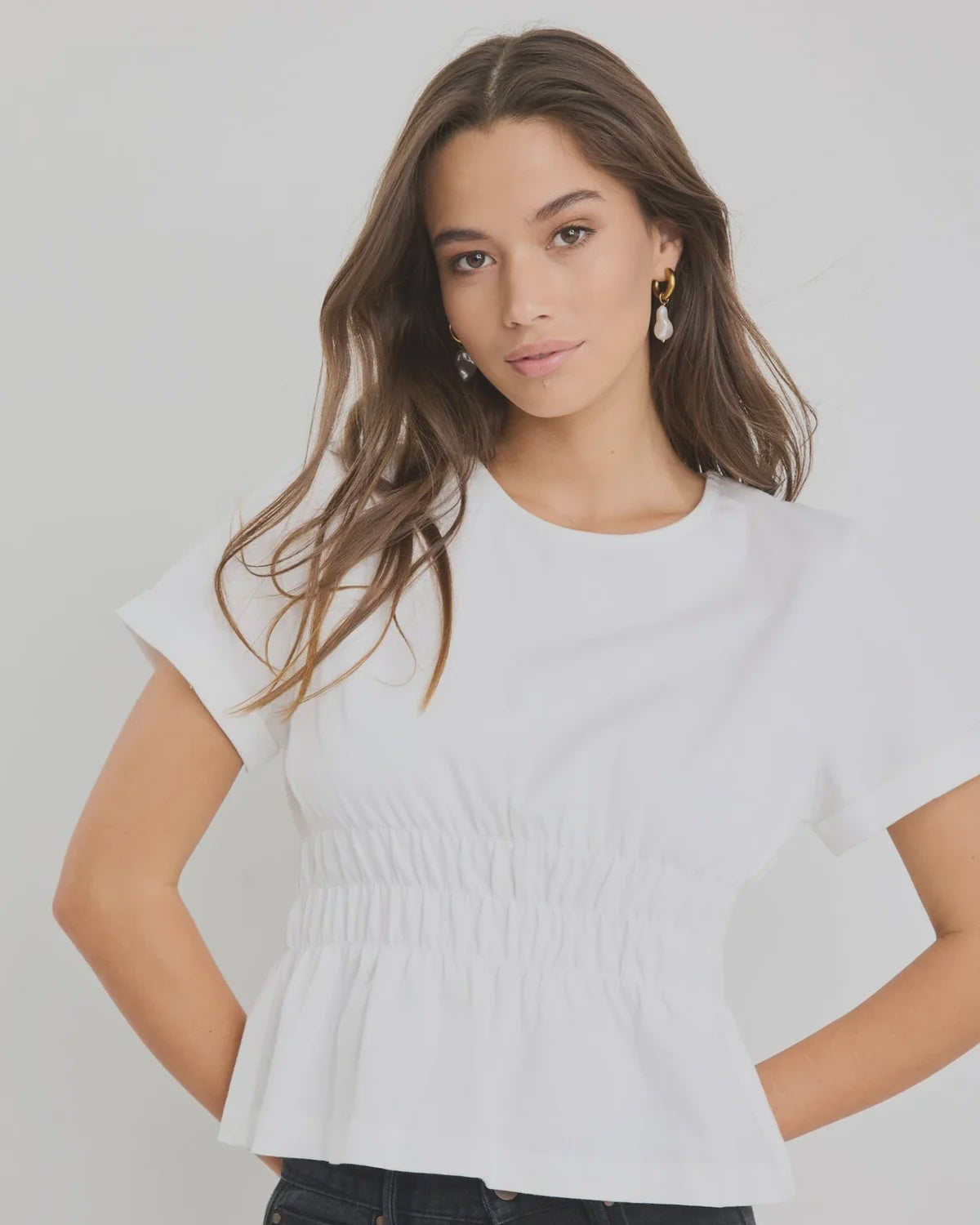 Classic crew neckline for timeless style

Short sleeves with rolled cuffs

Shirred waist detail for a flattering, tailored fit

Flared peplum-style hem for feminine movement

Made from soft, breathable 100% cotton