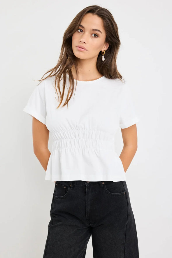 Classic crew neckline for timeless style

Short sleeves with rolled cuffs

Shirred waist detail for a flattering, tailored fit

Flared peplum-style hem for feminine movement

Made from soft, breathable 100% cotton