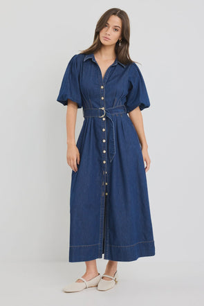 Dark indigo denim dress with a structured silhouette

Button-down front and panel seam detailing

D-ring belt for an adjustable, flattering fit

Soft puff sleeves with gentle volume

80% Cotton, 20% Polyester – durable yet comfortable

Style it casual or elevated for endless versatility
