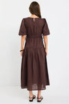 100% linen for breathable, natural comfort

Puff sleeves with soft volume for a feminine touch

Adjustable waist ties for a custom fit

Tiered skirt adds movement and flow

Midi length for timeless, versatile styling

Chocolate brown hue for an elegant, earthy look

Perfect for both casual wear and dressier occasions