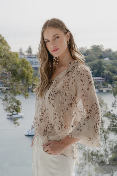 Oversized fit with romantic puff sleeves

Lightweight fabric with a soft, flowy drape

Unique floral-inspired animal print for a modern twist

Easy pull-on style for comfort and ease

Made from 100% polyester for a silky-soft feel