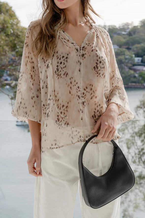 Oversized fit with romantic puff sleeves

Lightweight fabric with a soft, flowy drape

Unique floral-inspired animal print for a modern twist

Easy pull-on style for comfort and ease

Made from 100% polyester for a silky-soft feel 