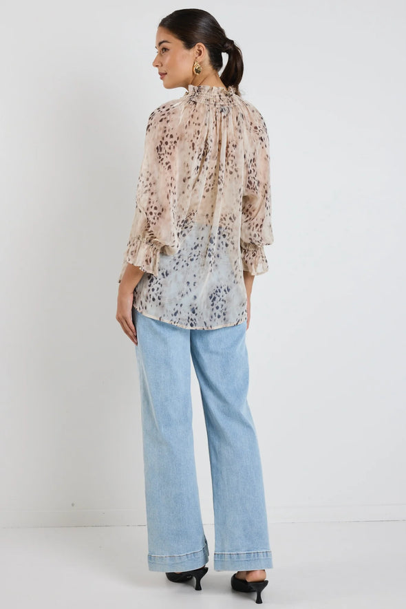 Oversized fit with romantic puff sleeves

Lightweight fabric with a soft, flowy drape

Unique floral-inspired animal print for a modern twist

Easy pull-on style for comfort and ease

Made from 100% polyester for a silky-soft feel