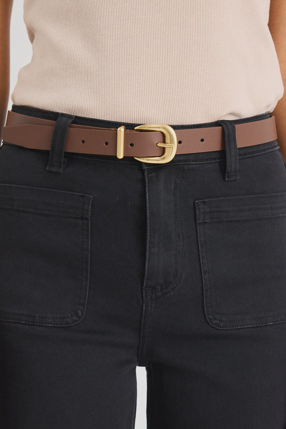 Elevate your everyday style with the sand leather belt from Among The Brave. Crafted from 3A grade leather, this versatile accessory features a sleek design complemented by a gold-tone buckle for a touch of sophistication. Perfect for cinching your favourite jeans or adding definition to dresses, this belt effortlessly enhances any outfit. Pair it with gold earrings to tie your look together!