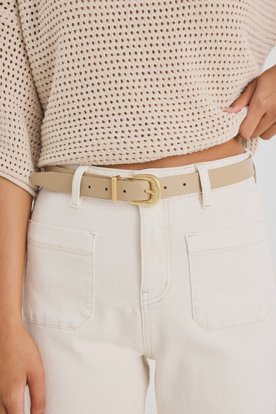 Elevate your everyday style with the sand leather belt from Among The Brave. Crafted from 3A grade leather, this versatile accessory features a sleek design complemented by a gold-tone buckle for a touch of sophistication. Perfect for cinching your favourite jeans or adding definition to dresses, this belt effortlessly enhances any outfit. Pair it with gold earrings to tie your look together!