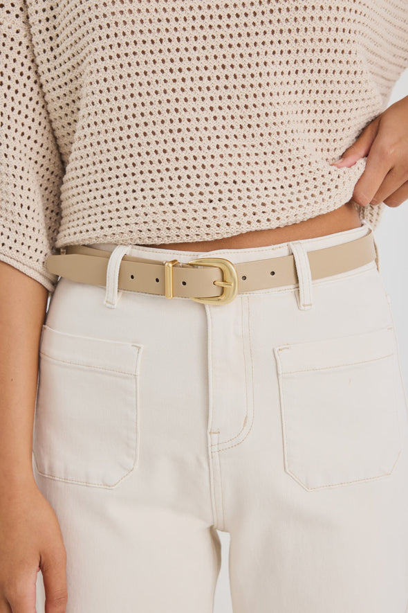 Elevate your everyday style with the sand leather belt from Among The Brave. Crafted from 3A grade leather, this versatile accessory features a sleek design complemented by a gold-tone buckle for a touch of sophistication. Perfect for cinching your favourite jeans or adding definition to dresses, this belt effortlessly enhances any outfit. Pair it with gold earrings to tie your look together!