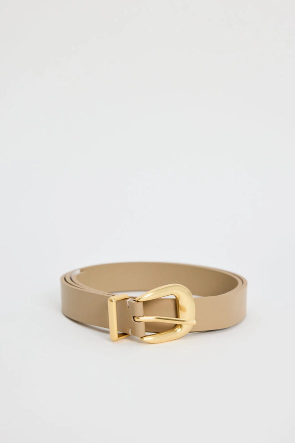Elevate your everyday style with the sand leather belt from Among The Brave. Crafted from 3A grade leather, this versatile accessory features a sleek design complemented by a gold-tone buckle for a touch of sophistication. Perfect for cinching your favourite jeans or adding definition to dresses, this belt effortlessly enhances any outfit. Pair it with gold earrings to tie your look together!