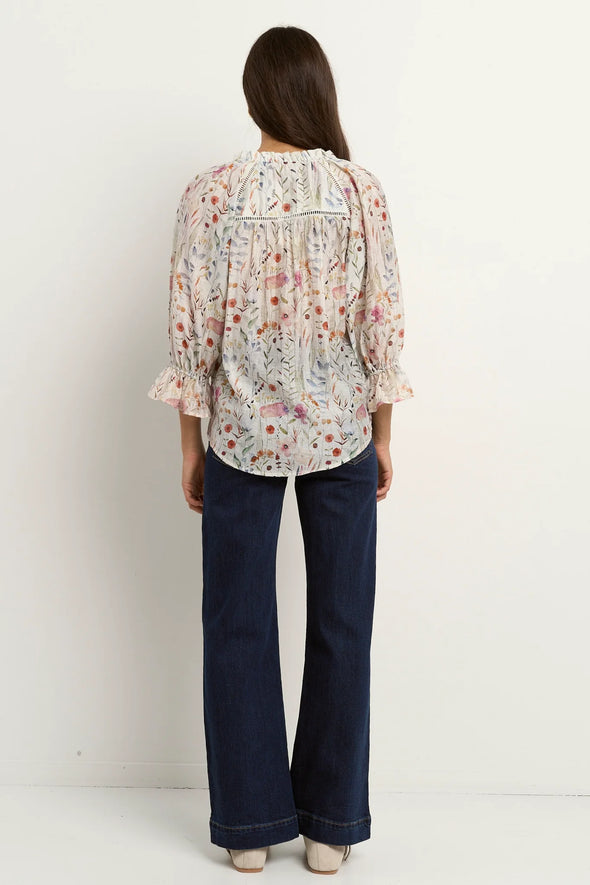 Add a playful touch to your wardrobe with the Encounter cream top. Delicate lace inserts at the shoulders and frilly details on the collar and sleeve cuffs bring a sweet, feminine vibe. The flattering V-neckline and button front make it easy to wear, while short sleeves keep you cool and breezy all summer long. Perfect for brightening up any outfit with a charming twist!