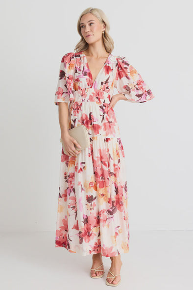 The Fluent vintage blush maxi dress gives off elegance and femininity with its v neck and flutter sleeves. The long flowing tiered maxi skirt adds a touch of romance to this fully lined floral dress. Perfect for any occasion, this dress will make you feel confident and beautiful. Add a pair of heels for a fun night out, or some sandals to relax in the sun.&nbsp;