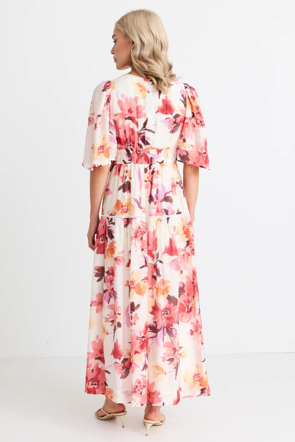 The Fluent vintage blush maxi dress gives off elegance and femininity with its v neck and flutter sleeves. The long flowing tiered maxi skirt adds a touch of romance to this fully lined floral dress. Perfect for any occasion, this dress will make you feel confident and beautiful. Add a pair of heels for a fun night out, or some sandals to relax in the sun.&nbsp;