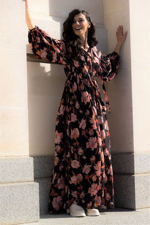 We are crushing on this gorgeous maxi dress. Floral amd fantastic with a pink and autumnal tone print pair with a boot and you've got yourself a cute AF outfit. Black base print which makes the print that much more eye-catching with the colours able to shine. The dress features a waist drawstring tie allowing you to create a waist line and a button down placket you can adjust the neckline to your desired depth. Long statement sleeve anchored with a button closure at the cuff and a dropped shoulder seam.