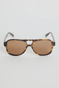 The Cannes Tort Aviator Sunglasses bring a sleek, modern twist to the classic aviator shape. Designed with a bold tortoiseshell frame and softly rounded aviator lenses, they offer that effortless mix of statement and sophistication. Warm brown lenses keep the look cohesive and flattering, making this pair an easy go-to for sunny days, road trips, and everyday wear.

A timeless style with a chic, contemporary edge.

- Modern aviator shape
- Tortoiseshell frame
- Brown tinted lenses
- Angular top bar detail
-