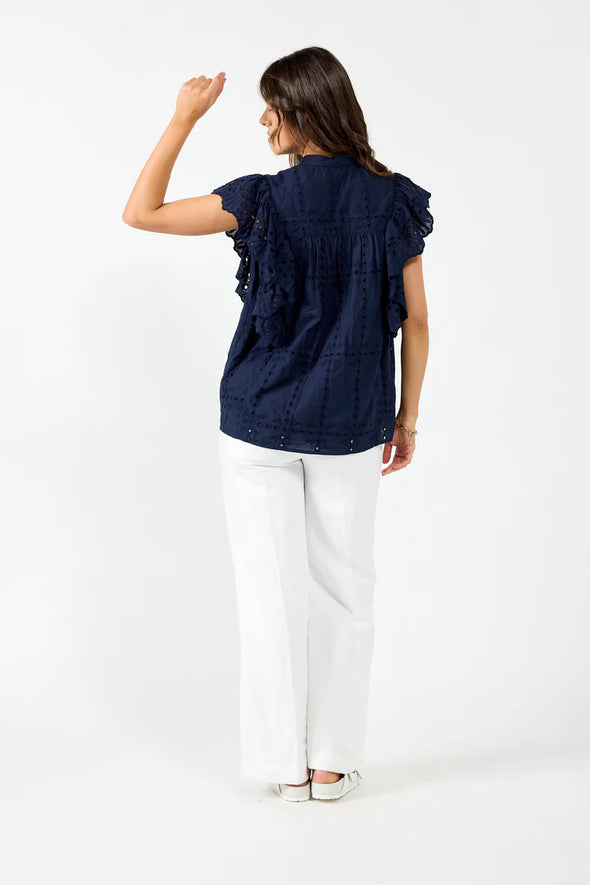 Elevate your summer wardrobe with Drama the Label's "Cards Top". This elegant top features delicate Embroidery Anglaise and a stylish Chinese Collar, along with a half-placket Button front and Sleeveless design. The cascading Frill adds a touch of grace, and the top is fully lined for comfort and quality. Pair it with Drama Shorts or Pants for a chic and sophisticated look!