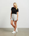 Fresh and summery in white and black cotton blend plaid, these cute shorts with front pleat detail and self belt are a must have. &nbsp;Style with a tank top or t-shirt for the beach or with the Kennedy Blazer in the matching fabric for an elevated summer 'suit' option.&nbsp;

COLOUR
White Plaid

FABRIC INFO
80% Cotton 20% Poly