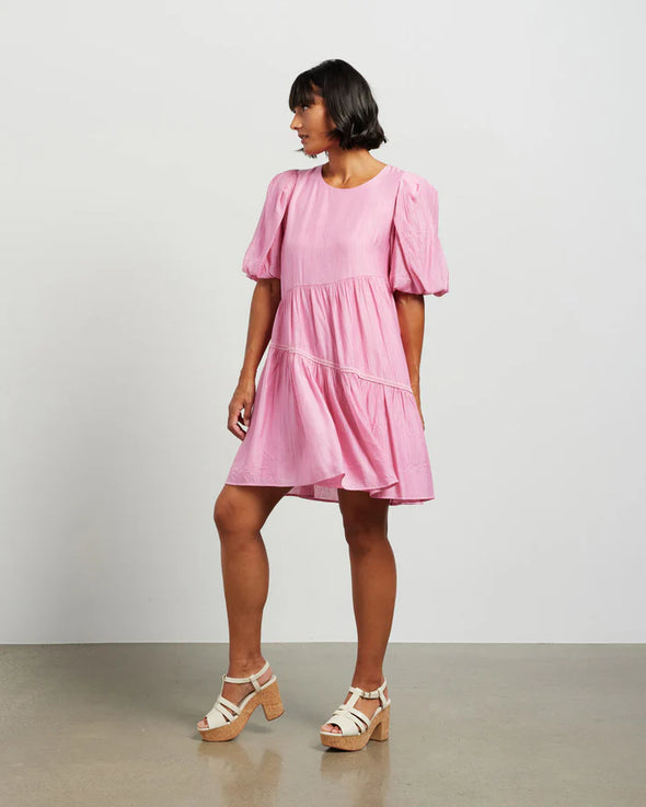 Get ready to embrace effortlessly cool vibe in our cute Becks Dress. Showcasing pretty puff sleeves for a playful touch, while the flared body with a asymmetric skirt panels adds movement and ease. The round neck and the lovely rayon blend fabric ensures comfort and style all day long. A must have for summer, dress up with strappy sandals or down with flats.

COLOUR
Barbie Pink

FABRIC INFO
85% Rayon 15% Nylon