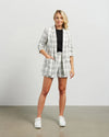 Blazers are having a big moment in fashion, and this style is on-trend with a slight masculine cut and longer length. This chic summer blazer is crafted in cotton blend plaid fabric and is fully lined, and the shorter length sleeves with tucked pleats at the elbow give it a relaxed vibe.

COLOUR
White Plaid

FABRIC INFO
80% Cotton 20% Poly