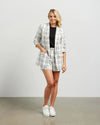 Blazers are having a big moment in fashion, and this style is on-trend with a slight masculine cut and longer length. This chic summer blazer is crafted in cotton blend plaid fabric and is fully lined, and the shorter length sleeves with tucked pleats at the elbow give it a relaxed vibe.

COLOUR
White Plaid

FABRIC INFO
80% Cotton 20% Poly