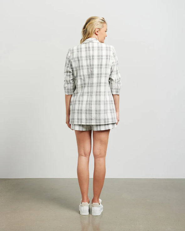 Blazers are having a big moment in fashion, and this style is on-trend with a slight masculine cut and longer length. This chic summer blazer is crafted in cotton blend plaid fabric and is fully lined, and the shorter length sleeves with tucked pleats at the elbow give it a relaxed vibe.

COLOUR
White Plaid

FABRIC INFO
80% Cotton 20% Poly