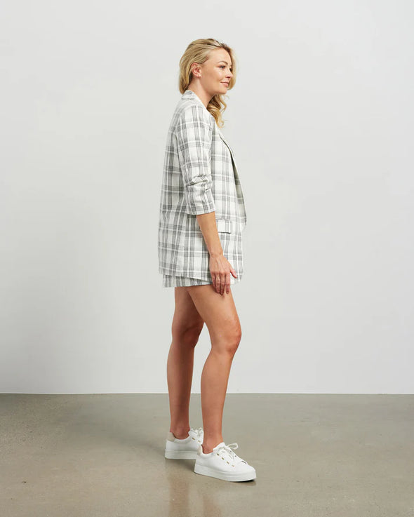 Blazers are having a big moment in fashion, and this style is on-trend with a slight masculine cut and longer length. This chic summer blazer is crafted in cotton blend plaid fabric and is fully lined, and the shorter length sleeves with tucked pleats at the elbow give it a relaxed vibe.

COLOUR
White Plaid

FABRIC INFO
80% Cotton 20% Poly