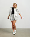 Blazers are having a big moment in fashion, and this style is on-trend with a slight masculine cut and longer length. This chic summer blazer is crafted in cotton blend plaid fabric and is fully lined, and the shorter length sleeves with tucked pleats at the elbow give it a relaxed vibe.

COLOUR
White Plaid

FABRIC INFO
80% Cotton 20% Poly