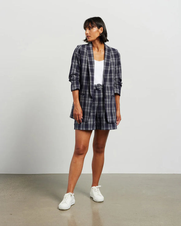 Blazers are having a big moment in fashion, and this style is on-trend with a slight masculine cut and longer length. This chic summer blazer is crafted in cotton blend plaid fabric and is fully lined, and the shorter length sleeves with tucked pleats at the elbow give it a relaxed vibe.

COLOUR
Ink Plaid

FABRIC INFO
80% Cotton 20% Poly